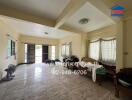 Spacious main living area with multiple windows and minimal furnishings