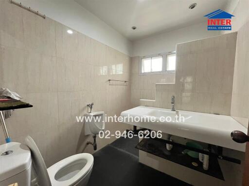 Bathroom with modern fixtures and neutral tile decor