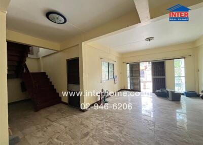 Spacious living room with tiled flooring and ample natural light