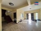 Spacious living room with tiled flooring and ample natural light