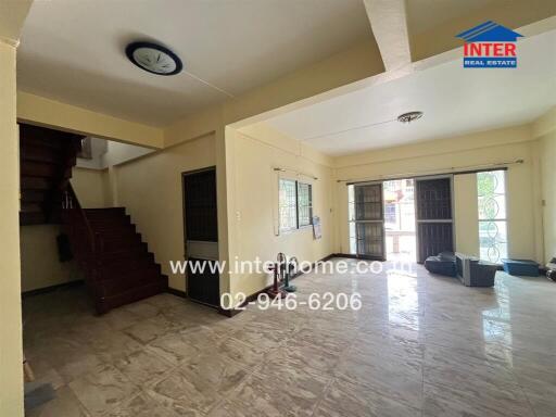 Spacious living room with tiled flooring and ample natural light