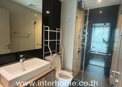 Modern bathroom with sleek fixtures and a spacious shower area