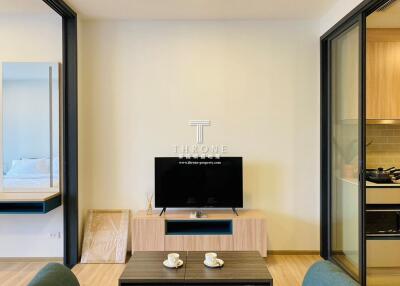 Modern living area with TV and small dining table