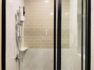 Modern bathroom with a standing shower and sliding glass doors