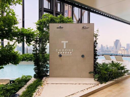 outdoor pool area with shower and city skyline view