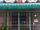 Front view of a colorful townhouse with gated porch