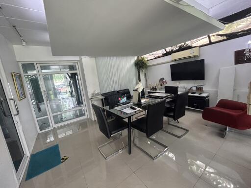 Modern dining area with glass table and black chairs