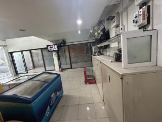 Commercial space with glass doors, electrical equipment, and freezer