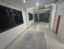 Hallway with tiled flooring and glass doors