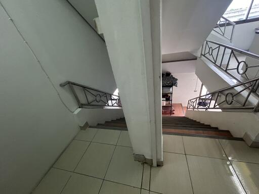 Clean and well-lit staircase with metal railings