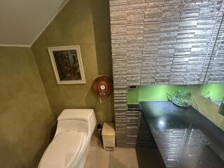 Modern bathroom with unique wall design and toilet