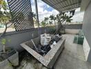 Outdoor balcony with planting area and potted plants