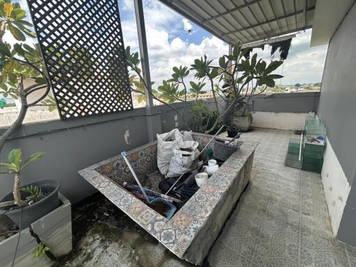 Outdoor balcony with planting area and potted plants