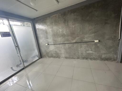 Unfurnished room with polished tiles and frosted glass sliding door