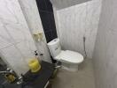 Compact bathroom with toilet and tiled walls