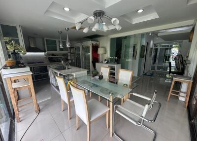Modern kitchen and dining area with glass table and chairs