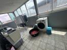Laundry room with washing machine and clothes drying rack