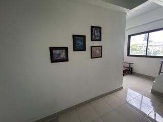 Hallway with framed pictures on the wall