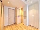 Spacious bedroom with wooden flooring and built-in wardrobes