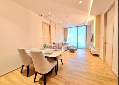 Modern living and dining area with wooden flooring and plenty of natural light