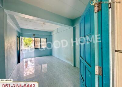Spacious living area with blue walls and tiled floor