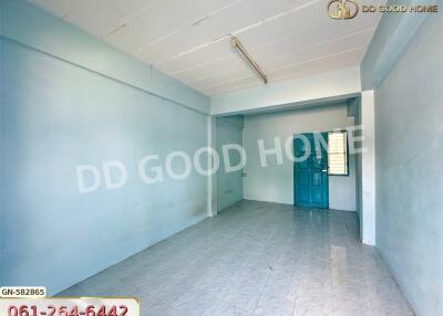 empty room with blue door and white tiled floor