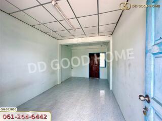 Simple empty room with tiled floor and partially open door