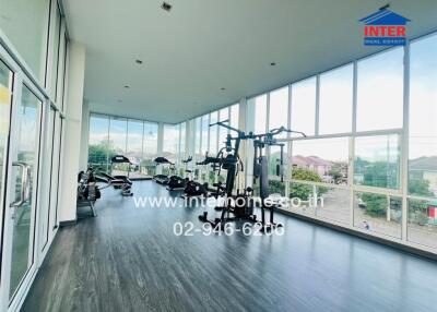 Bright and spacious gym with modern equipment and floor-to-ceiling windows