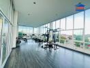 Bright and spacious gym with modern equipment and floor-to-ceiling windows