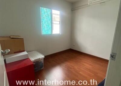 Small bedroom with wooden flooring and window