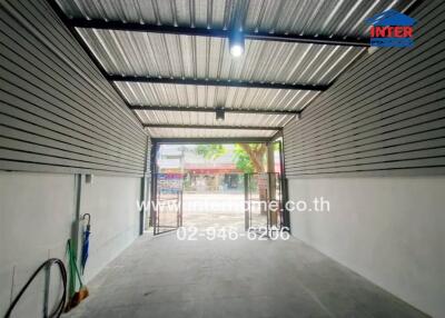 Covered garage with open gate