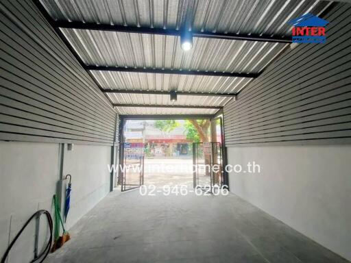 Covered garage with open gate