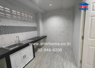 Modern kitchen with marble walls and a sink