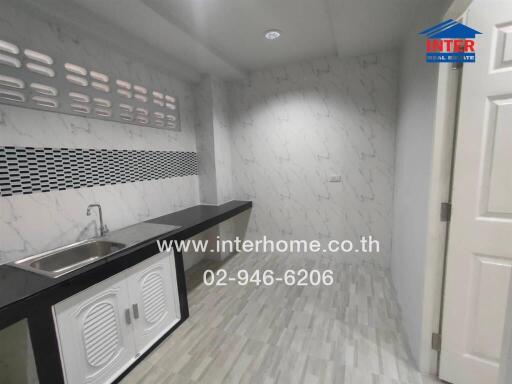 Modern kitchen with marble walls and a sink