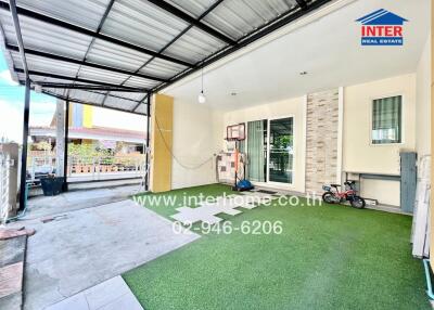 Covered outdoor space with artificial grass and sports equipment