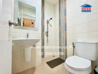 Modern bathroom with sink, mirror, toilet, and shower