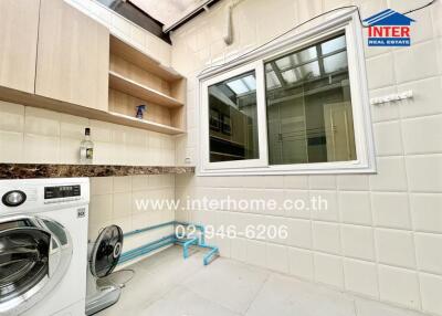 Bright and clean laundry room with washer