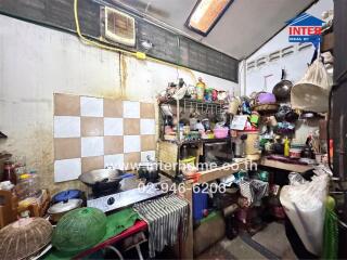 Cluttered kitchen with various utensils and appliances