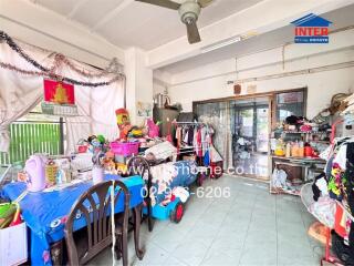 Cluttered room with furniture and various items