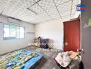 Bedroom with basic furnishings, a mattress, and tiles floor