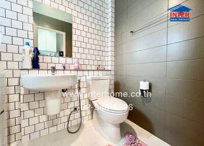 Modern bathroom with tiled walls and sanitary fixtures