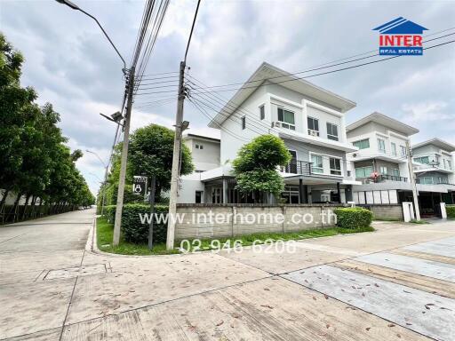 Three-story modern house at the corner of a residential street