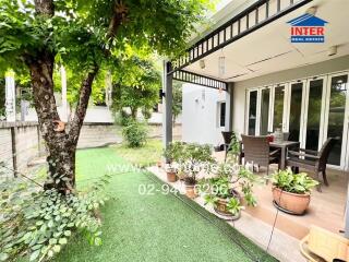 Outdoor patio with seating area and garden