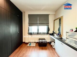 Spacious bedroom with built-in wardrobe and vanity area