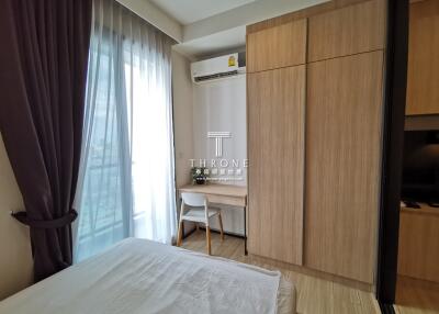A bedroom featuring a desk, wardrobe and air conditioning