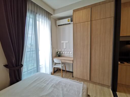 A bedroom featuring a desk, wardrobe and air conditioning