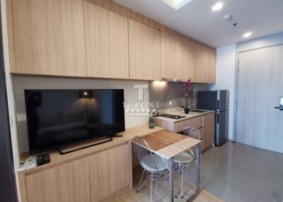 Modern kitchen with TV, dining table, and appliances