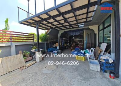 Covered outdoor area with miscellaneous items and garage tools