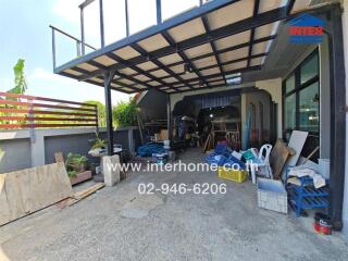 Covered outdoor area with miscellaneous items and garage tools