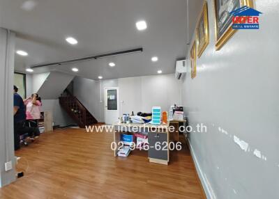 Spacious Living Area with Wooden Flooring and Staircase